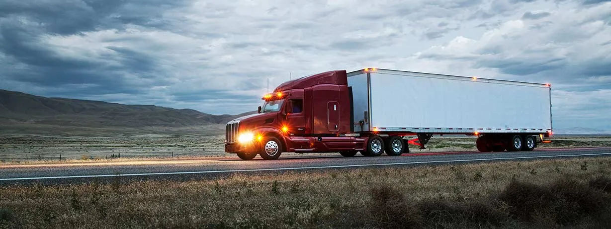 Semi-truck on the road at dusk